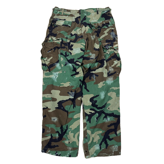 distressed with paint and studs Camouflage pants on a white background