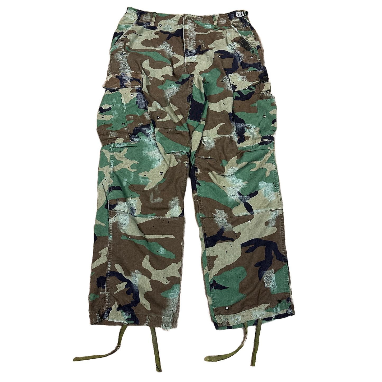 distressed with paint and studs Camouflage pants on a white background