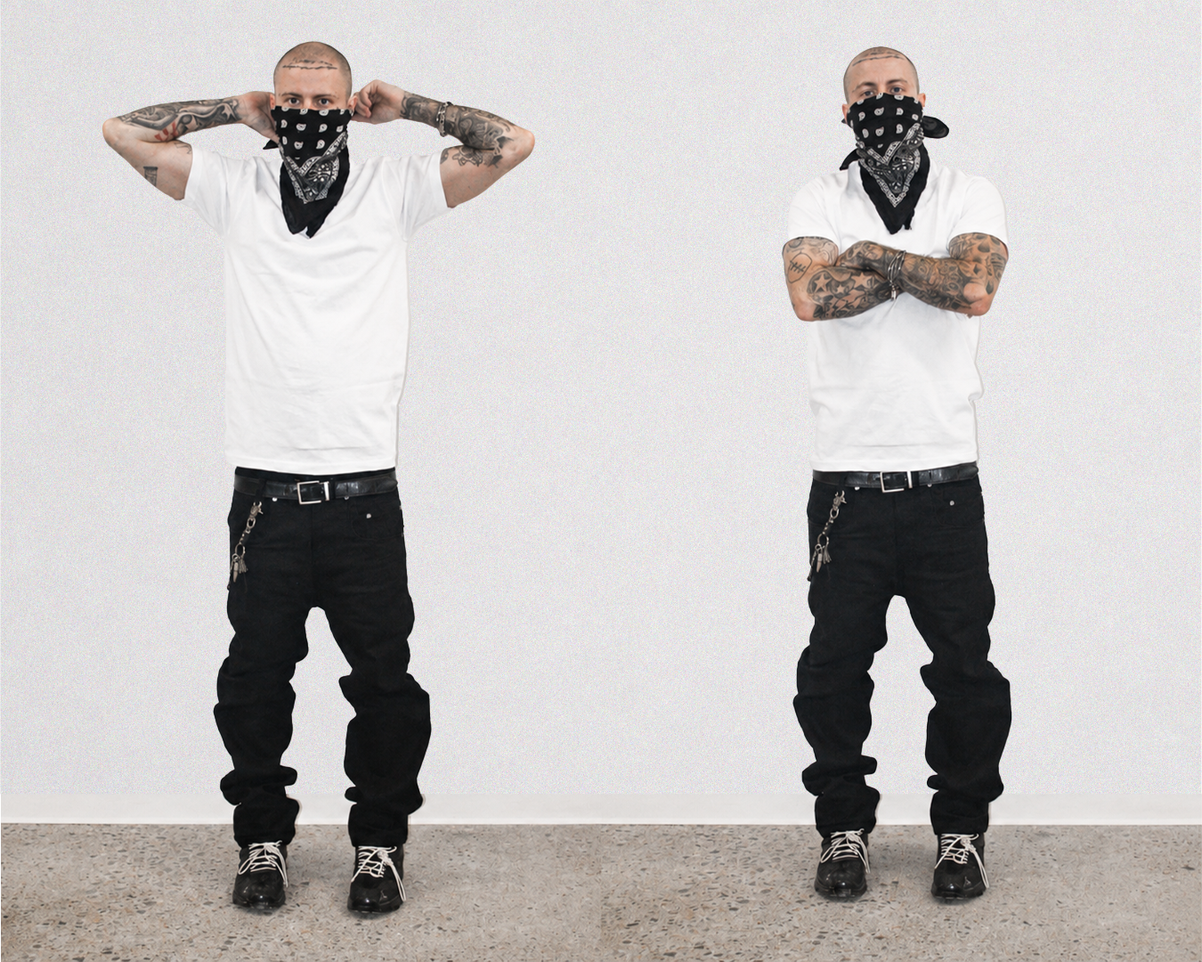 A man wearing a white t-shirt, black jeans, and black sneakers is shown twice side-by-side against a plain white wall. In both poses, he wears a black bandana with a white graphic print over his face, with one pose having his hands behind his head and the other with his arms crossed.